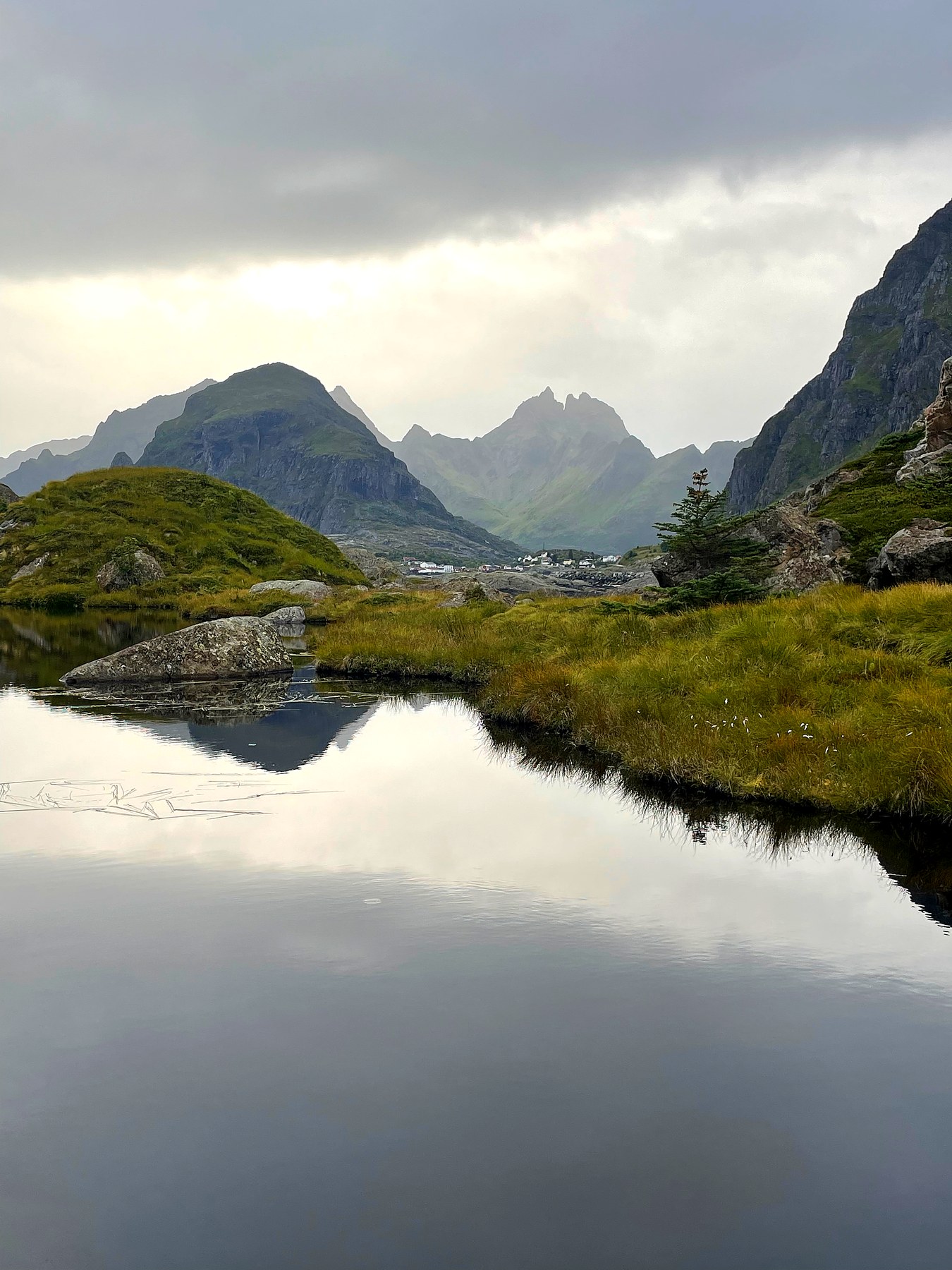 Tjern med fjellene speilet i vannet